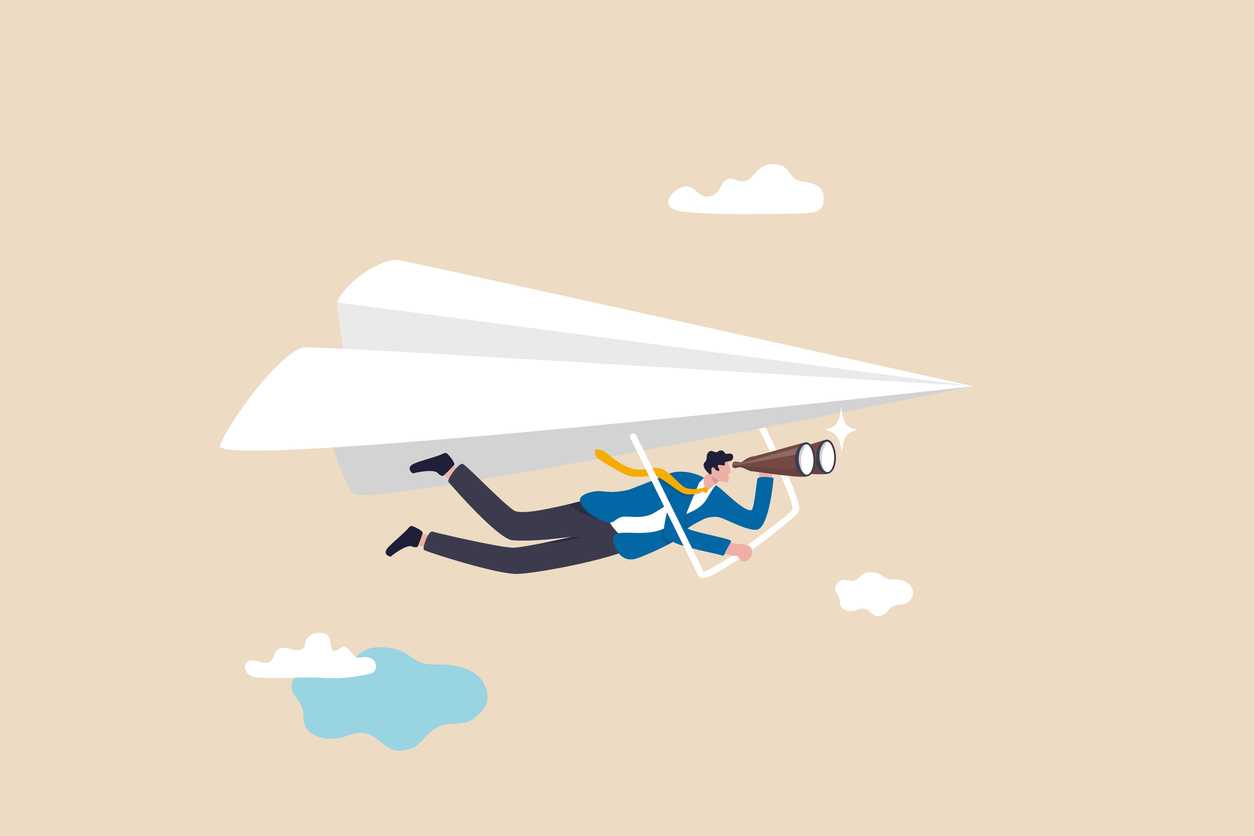 businessman flying paper airplane origami as glider with binoculars